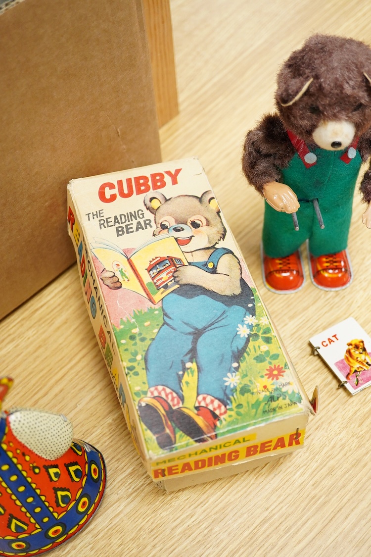 Three boxed clockwork tinplate toys - a 1960s Japanese Cubby the Reading Bear, by Alps (Japan), 17cm high, a USSR doll, and a later ‘Roli Zoli’ clown on a scooter (3)
